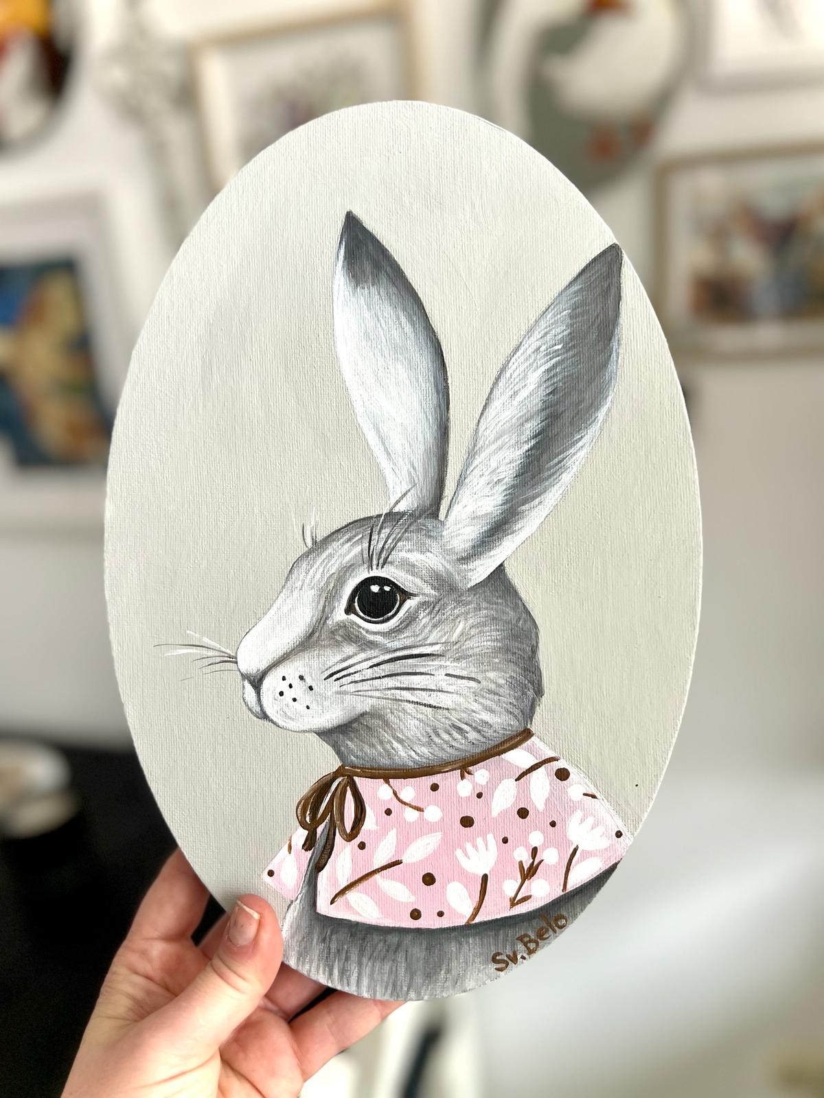 A gray rabbit with a pink collar. Acrylic painting on canvas, oval, 20*30 cm. Gift idea, wall decoration, country house decor.